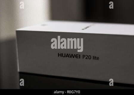 White box of a brand new P20 Lite mobile smartphone made by Chinese technology brand Huawei on a shiny black surface Stock Photo