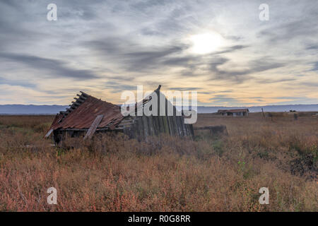 Sunset over abandoned house at Drawbridge, the last remaining ghost town in San Francisco Bay Area.