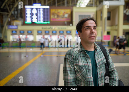 Handsome Persian tourist man at the railway station in Bangkok,  Stock Photo