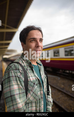 Handsome Persian tourist man at the railway station in Bangkok Stock Photo