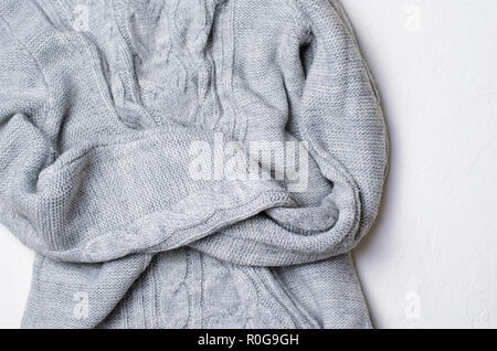 Grey Sweater on White Background, Knitted Winter Clothing, Top View Stock Photo