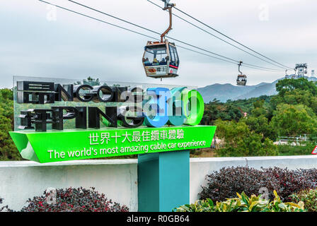 Hong Kong - January 26, 2016: Ngong Ping 360 Skyrail on Lantau Island in Hong Kong is the worlds most amazing cable car experience. Big sign on cablew Stock Photo