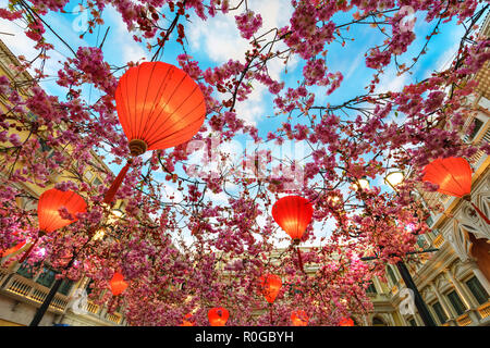 Macao, China - January 24, 2016: Red Chinese lanterns and sakura garlands as indoor decorations under artificial blue sky in The Venetian Macau Resort Stock Photo