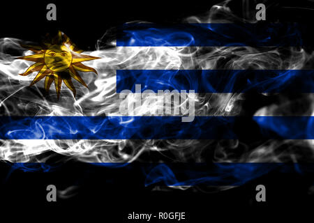 National flag of Uruguay made from colored smoke isolated on black background. Abstract silky wave background Stock Photo