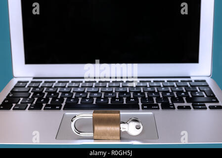 Modern computer with a lock and key in front - Concept of safe online password, web security, private information protection or internet hacker crime  Stock Photo