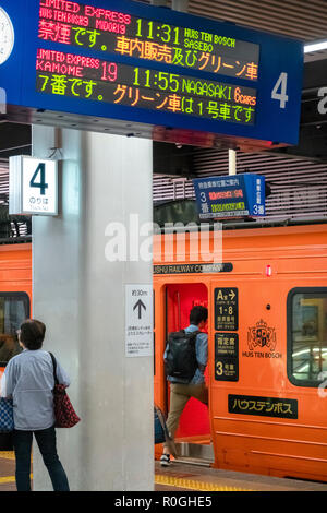 A special orange JR Kyushu Rail train to Huis Ten Bosch theme park in Sasebo is about to depart from Fukuoka Hakata Station. Stock Photo