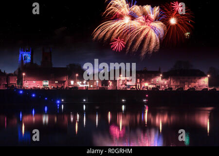 Fireworks at Kings Lynn in Norfolk UK 2018. Rockets exploding in a display over the Great River Ouse at night time. Historic town at night with reflec Stock Photo