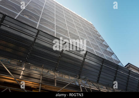 Buildiing on renovation.  Palace in maintenance. Scaffolding, protection net and debris protection Stock Photo