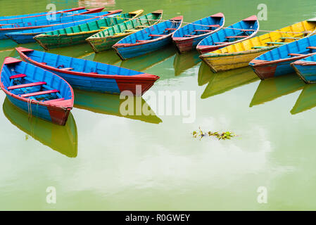 Pokhara, Nepal - July 31, 2018 : Colourful boats on Phewa lake in Pokhara, the most popular and visited lake of Nepal. Stock Photo