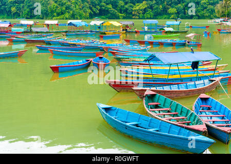 Pokhara, Nepal - July 31, 2018 : Colourful boats on Phewa lake in Pokhara, the most popular and visited lake of Nepal. Stock Photo