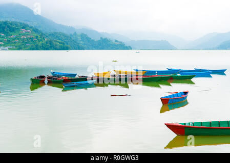 Pokhara, Nepal - July 31, 2018 : Colourful boats on Phewa lake in Pokhara, the most popular and visited lake of Nepal. Stock Photo