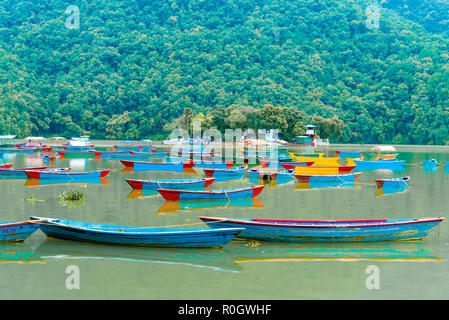 Pokhara, Nepal - July 31, 2018 : Colourful boats on Phewa lake in Pokhara, the most popular and visited lake of Nepal. Stock Photo