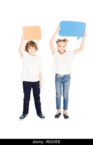 cheerful adorable children holding paper speech bubbles above heads isolated on white Stock Photo