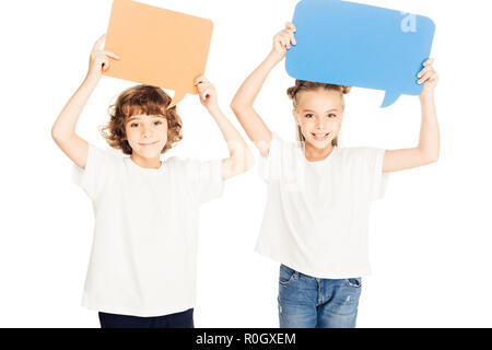 adorable smiling children holding paper speech bubbles above heads isolated on white Stock Photo