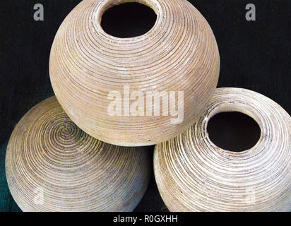 Ceramic products, a pile of round ribbed clay flower pots with round hole Stock Photo