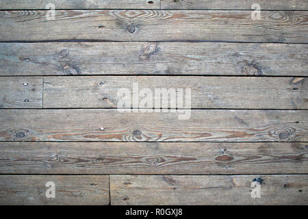 Old wooden gray flooring with knots and cracks, may be used as background Stock Photo