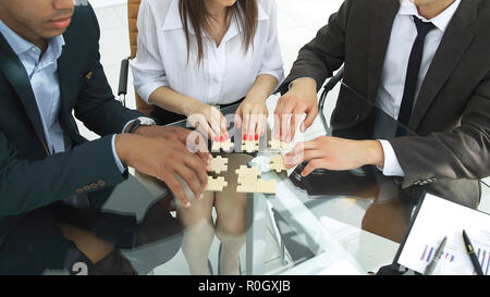 international business team assembling puzzle in the office Stock Photo