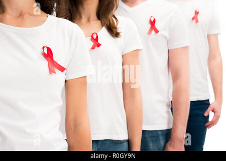 cropped image of people standing with red ribbons on shirts isolated on white, world aids day concept Stock Photo