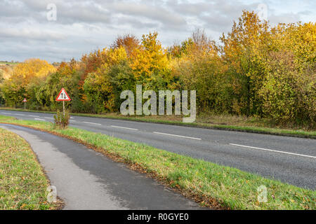 Two way traffic ahead road sign on a UK road during autumn, England, UK Stock Photo