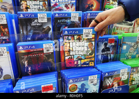 Store display filled with PlayStation 4 games for a home video game console. Stock Photo