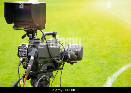 video camera put on the back of football goal for broadcast on TV sport channel. football program can't editing in studio. camera man is importance to Stock Photo