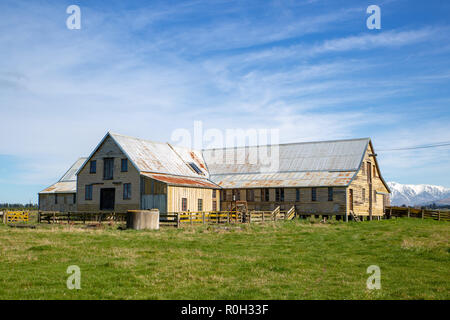 An old wooden shearing shed from days gone by still stands on a rural farm Stock Photo