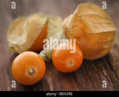 Fresh edible physalis on wooden surface Stock Photo