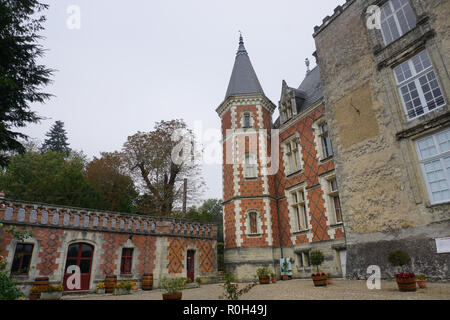 Side view of an old stone and red brick castle in a small provincial town in the country in France Stock Photo