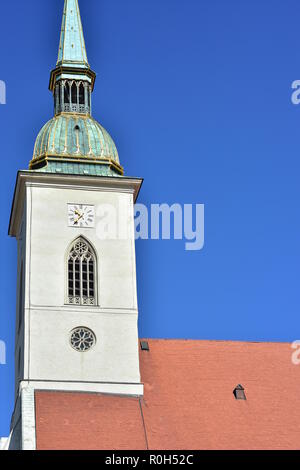 Gothic spire of St Martin cathedral of Roman Catholic archdiocese in Bratislava dominates skyline of Old Town. Stock Photo