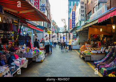 Busy street market scene in Busan, South Korea. Street is full or tourist and local people alike shopping. Stock Photo