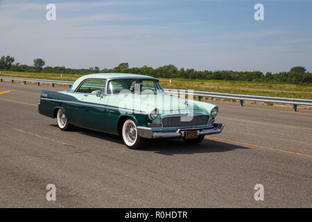 Green 1956 Chrysler New Yorker car on the road. Stock Photo