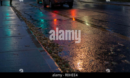 Walking on a rainy Autumn evening in The Village, my neighborhood in Toronto. The pavement reflected the dancing lights resembling the rainbow pattern Stock Photo