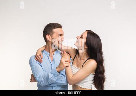 Emotions, fun and people concept - Funny couple laughing on white background Stock Photo