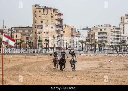 November 4, 2018 - Saida, Lebanon - Jockeys are seen competing during the horse race..Horse race at the Saida festival for speed, held on a public town beach, organised by a joint effort from the municipality of Sidon and the Ride-Along Club. (Credit Image: © Elizabeth Fitt/SOPA Images via ZUMA Wire) Stock Photo