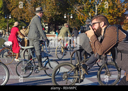 Washington DC, USA. 4th Nov 2018. Photographer at work during DC’s 2nd Tweed Ride event. The Ride of cyclists who refuse to endure anymore spandex and feel great to spin through our beautiful streets in the finest most dapper attire. Credit: Andrei Medvedev/Alamy Live News Stock Photo