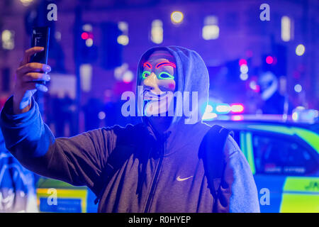 London, UK. 5th Nov 2018. The road is blocked for a while at Parliament square - Million Mask March, organised by Anonymous UK, every year on Guy Fawkes Night. Credit: Guy Bell/Alamy Live News Stock Photo