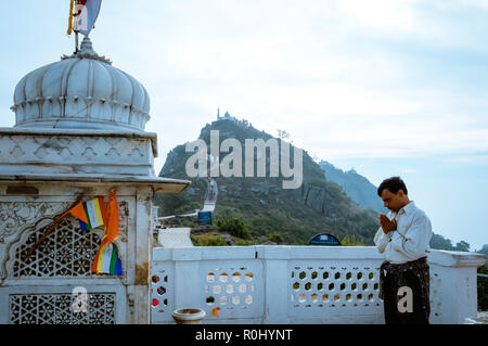 MUKTAGIRI, MADHYA PRADESH, INDIA MAY 5 2016: A jain pilgrim devotee meditating in front of famous historical Jainism Temple. Muktagiri Jain Pilgrim Stock Photo