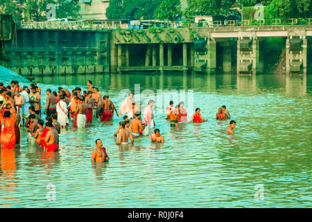 HARIDWAR, INDIA - JANUARY 14, 2016: Devotees taking holy dip at Har Ki Pauri on river Ganga on the first bath of Ardh Kumbh fair. People bathing Stock Photo