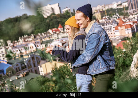 Young couple of travellers are hugging on the hill Stock Photo