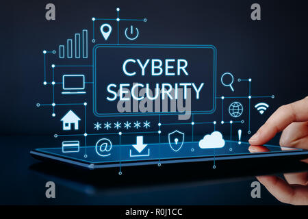 Hand touching tablet with cyber security and modern technology concept Stock Photo