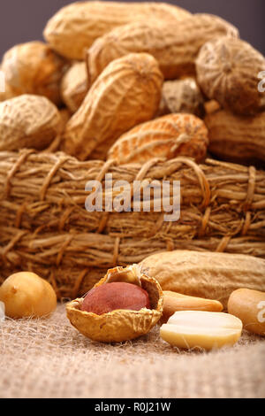 Peanuts in wicker basket and empty space for text Stock Photo