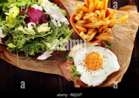English breakfast with bacon egg, fries and fresh salad Stock Photo