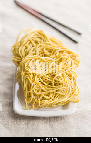 Uncooked instant chinese noodles on table. Stock Photo