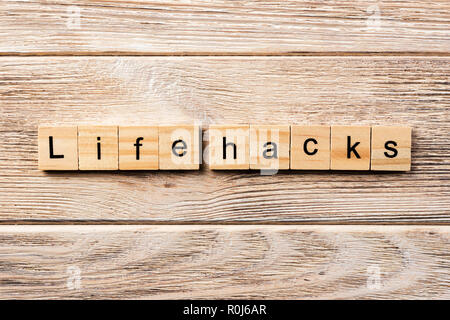 life hacks word written on wood block. life hacks text on table, concept. Stock Photo