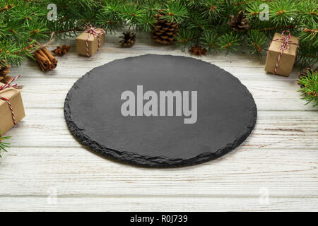 Perspective view. Empty plate on wooden christmas background. holiday dinner dish concept with new year decor. Stock Photo