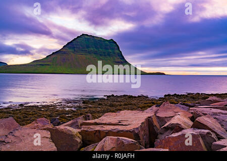 View of Kirkjufell mountain and the sea at twilight time at Grundarfjordur Village in West Iceland Stock Photo