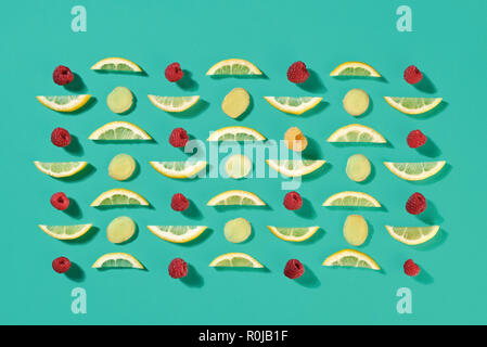 Ripe raspberry and lemon slices pattern of fruit on a blue background. Food layout. Flat lay Stock Photo