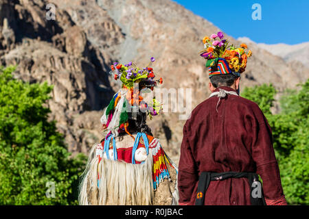 A couple of the Brokpa tribe, an arien race, who migrated to India from Persia, are wearing their traditional dresses. The main feature is a flower ar Stock Photo