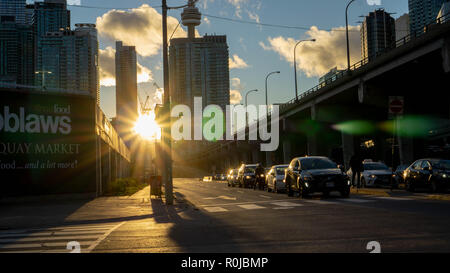 Highway 407 in downtown TO. The picture has been taken just before the golden hour when the sun is in its soft spot illuminating the city with gold. Stock Photo