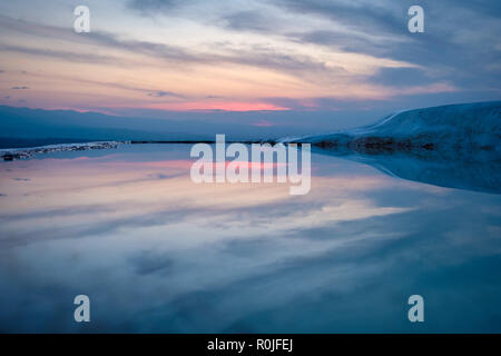 Beautiful sky reflecting on the water of a travertine mineral pool terrace at Pamukkale, Turkey Stock Photo